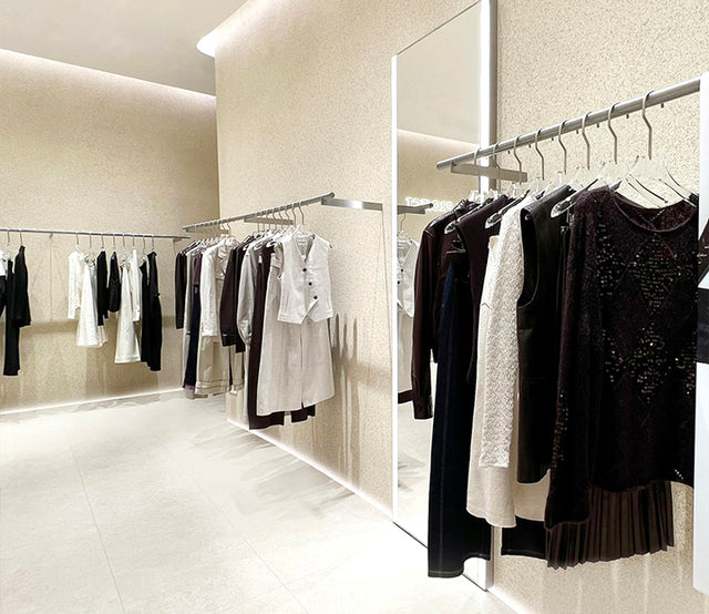 Clothing rack with various garments in a well-lit room