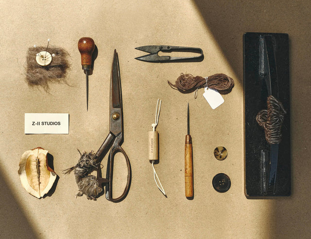 Collection of vintage tools and materials on a textured surface with 'Z-II STUDIOS' label.